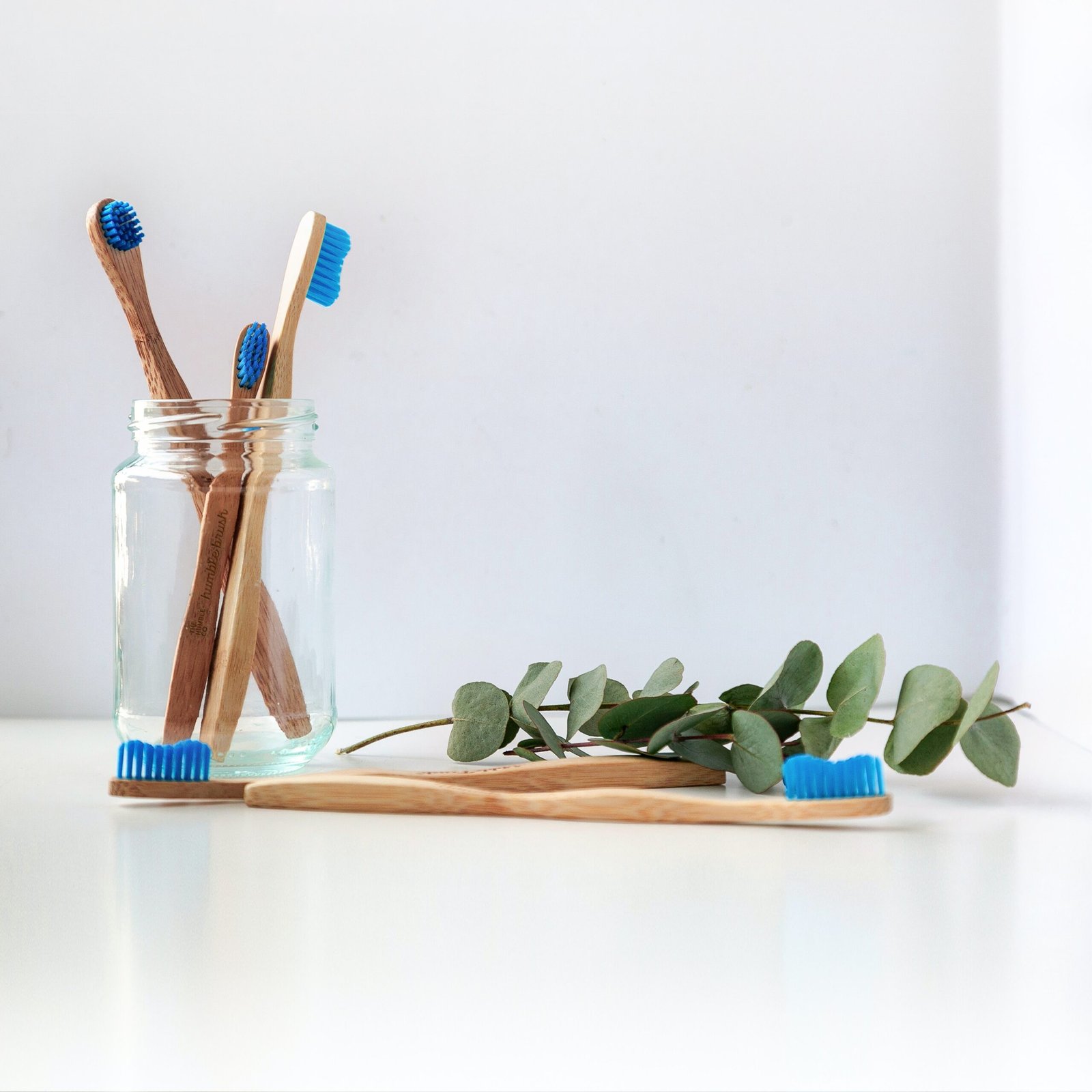 blue-and-white-toothbrush-in-clear-glass-jar-scaled Home